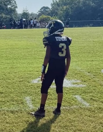 Brantly Stephens standing on the football sideline in his black and gold Temple Tigers number 3 uniform