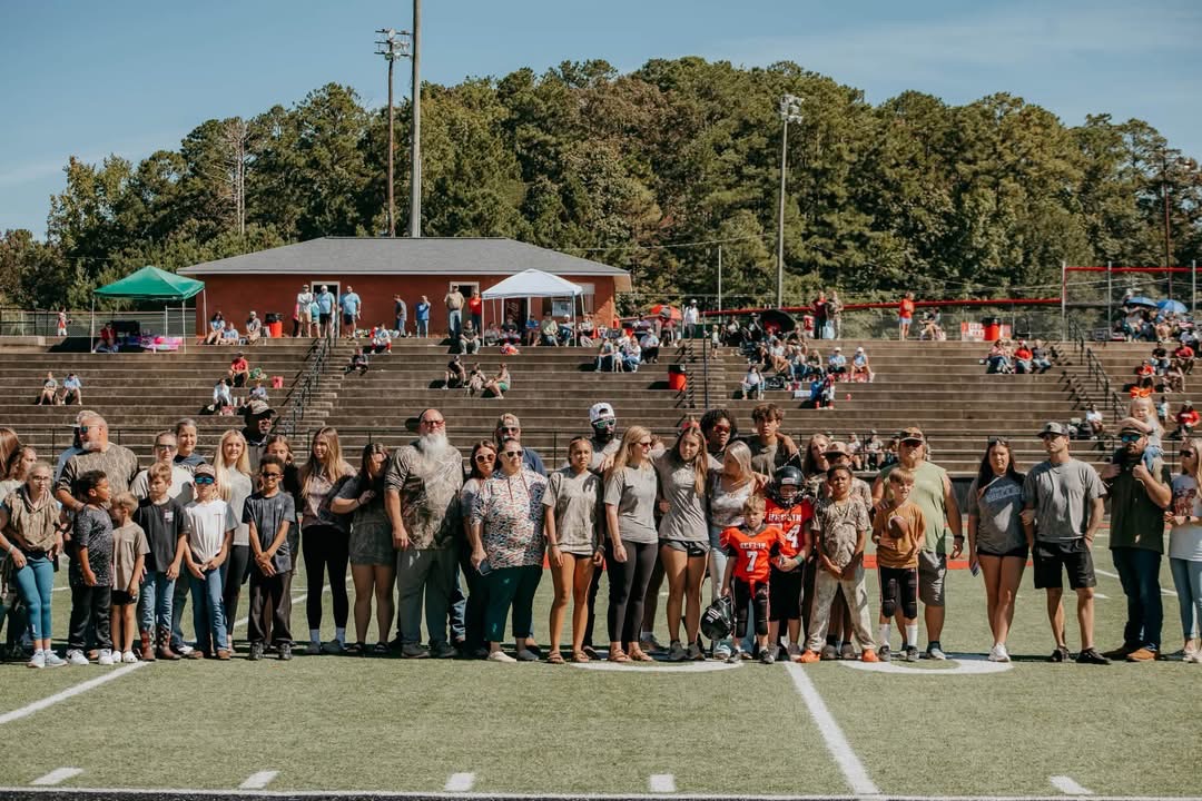 A wide view of the gathered family, teams, and friends.