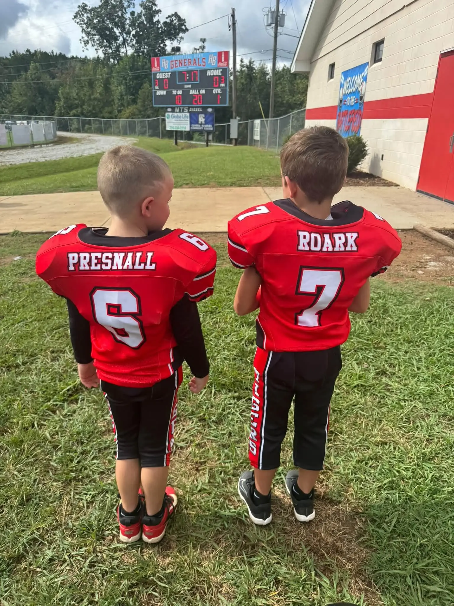 Two Heflin Tigers players watching the scoreboard