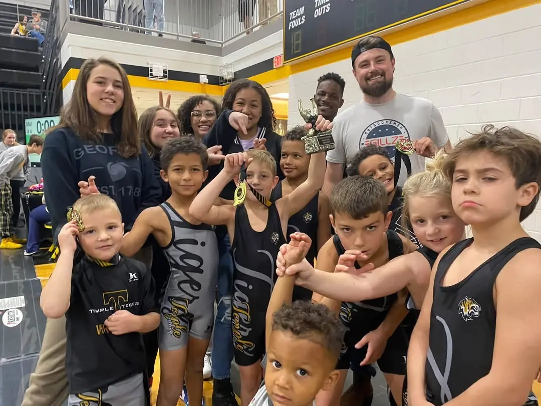 Temple Youth Wrestling teammates celebrating together after a tournament